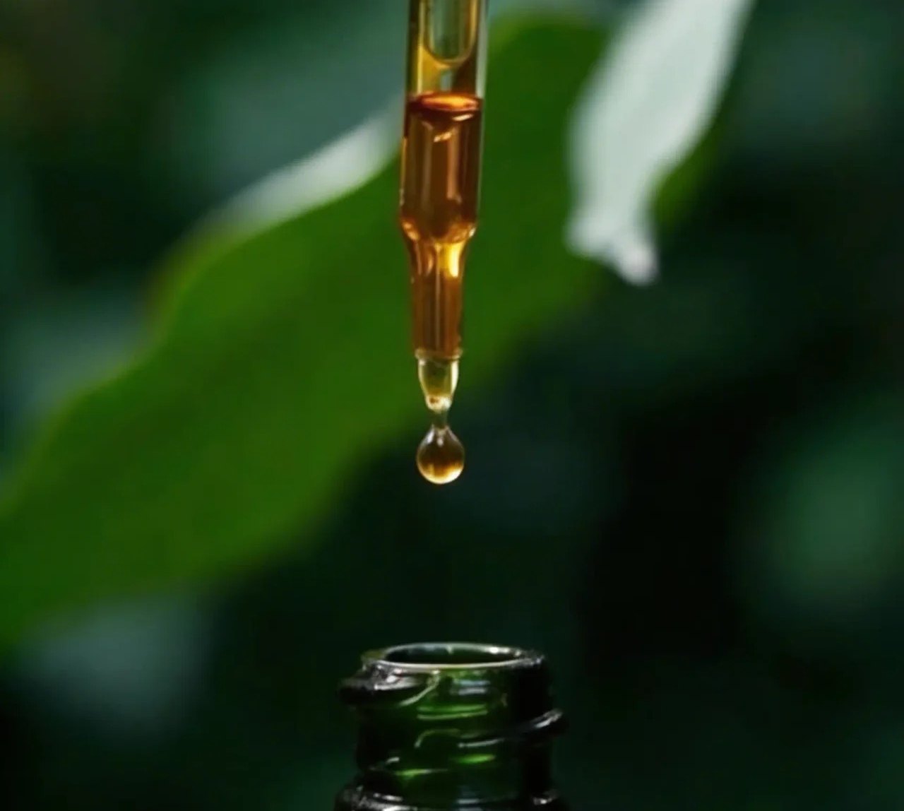 Essential oil dripping from a dropper
